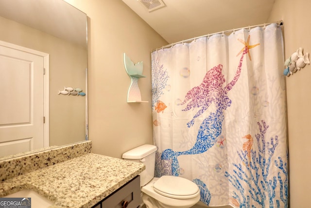 bathroom featuring vanity, toilet, and a shower with shower curtain