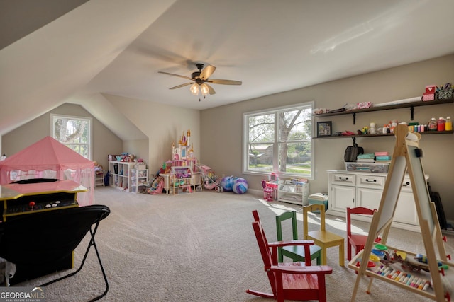 recreation room featuring light carpet, plenty of natural light, lofted ceiling, and ceiling fan