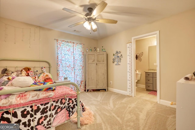 bedroom featuring connected bathroom, light carpet, and ceiling fan