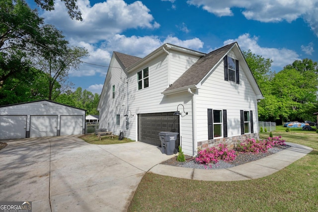 view of side of property with a garage and a lawn