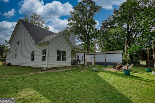 rear view of house featuring a lawn