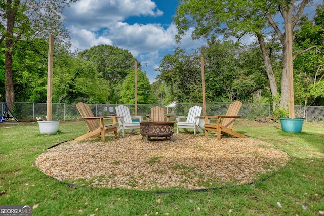 view of jungle gym with a lawn and an outdoor fire pit