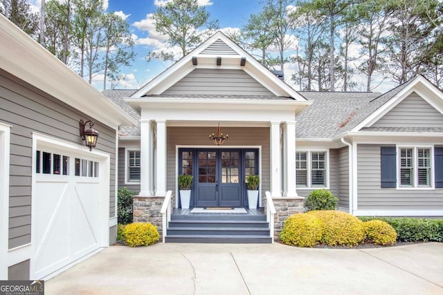 entrance to property featuring a garage and a porch