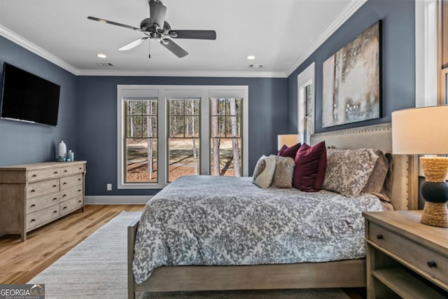 bedroom with hardwood / wood-style floors, crown molding, and ceiling fan