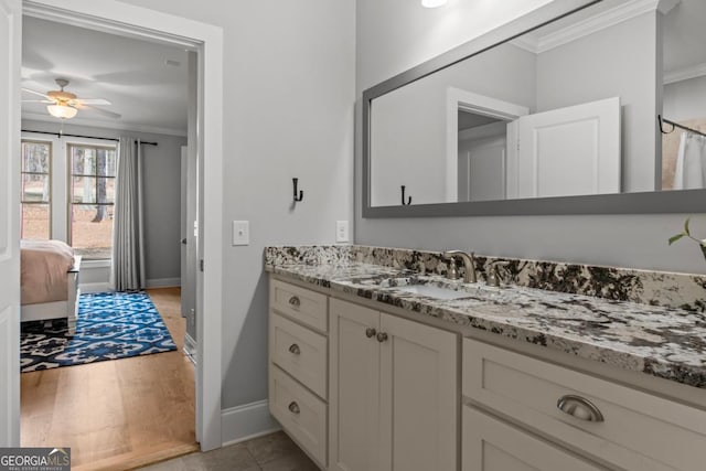 bathroom with vanity, crown molding, wood-type flooring, and ceiling fan