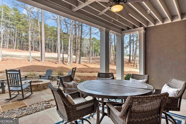 view of patio / terrace featuring ceiling fan and a fire pit