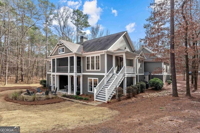 rear view of house featuring a sunroom and a patio