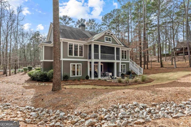 back of house featuring a sunroom