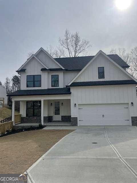 view of front of property featuring a porch and a garage