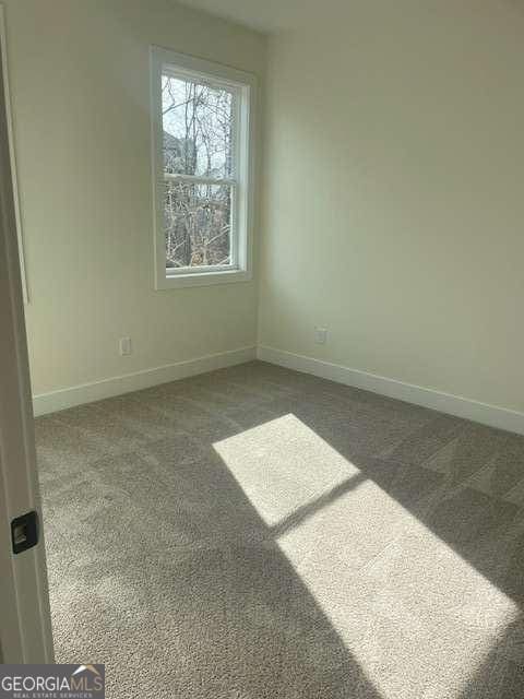 empty room featuring dark colored carpet