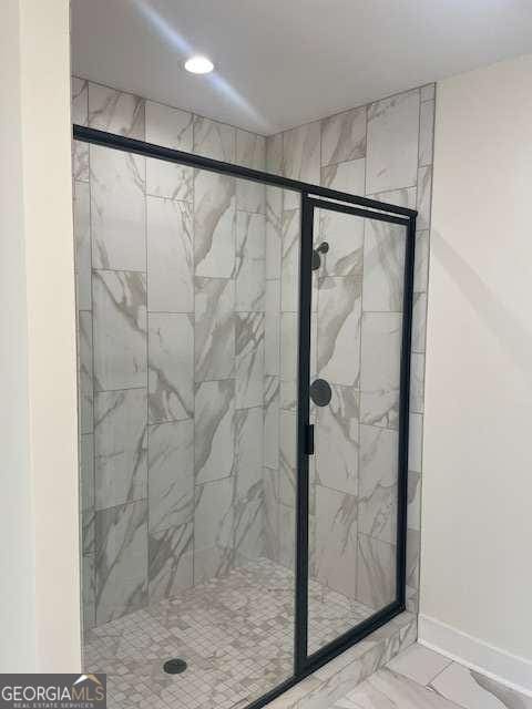 bathroom featuring a shower with shower door