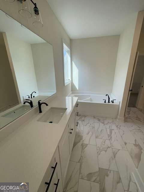 bathroom with vanity and a tub to relax in