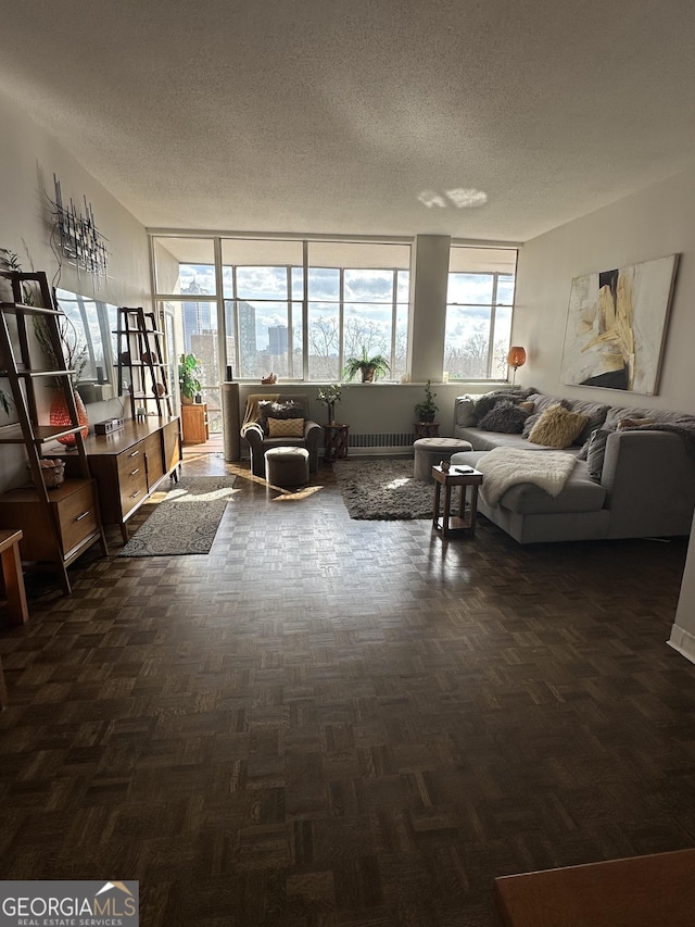 living room featuring radiator heating unit, dark parquet floors, and a textured ceiling