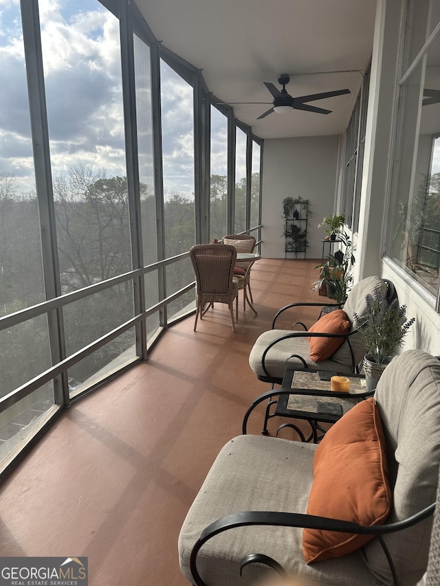 sunroom featuring ceiling fan