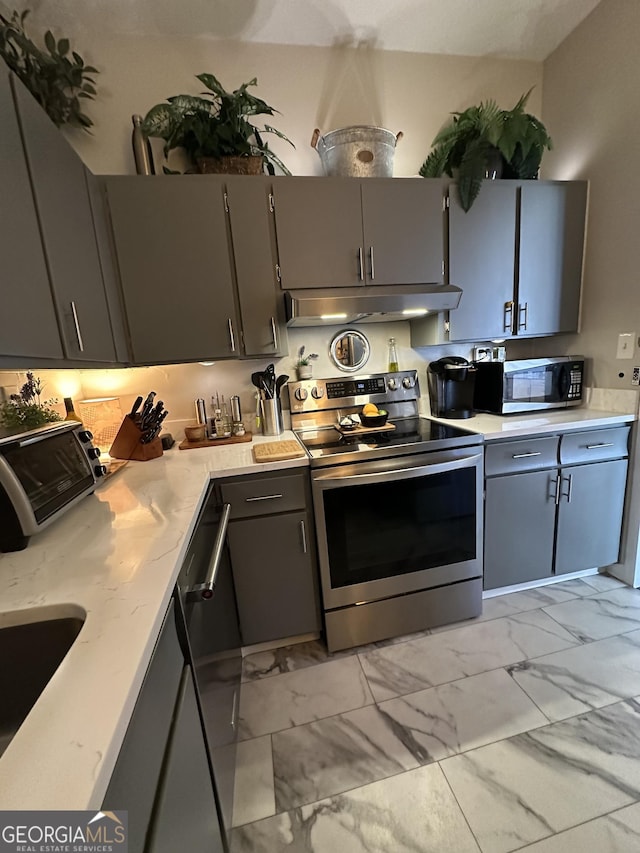 kitchen with gray cabinets, appliances with stainless steel finishes, and sink