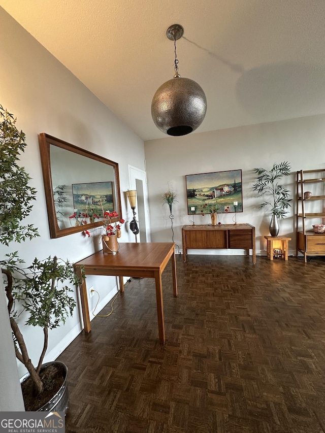 office area with dark parquet flooring and a textured ceiling