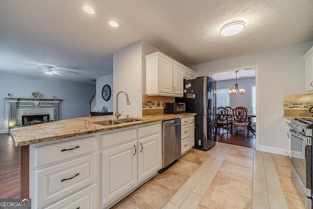 kitchen featuring white cabinetry, appliances with stainless steel finishes, sink, and decorative backsplash