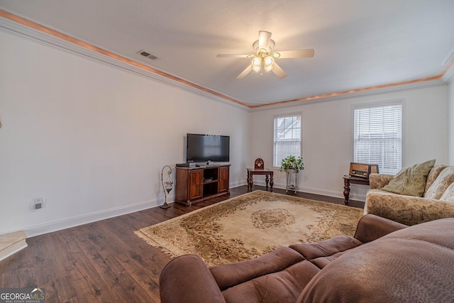 living room featuring crown molding, dark wood-type flooring, and ceiling fan