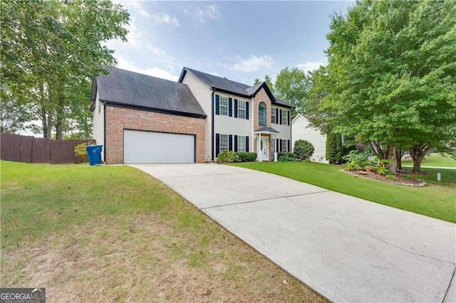 colonial-style house featuring a garage and a front yard