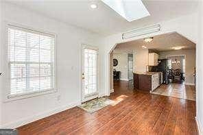 entryway featuring dark hardwood / wood-style flooring and a skylight