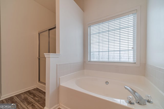 bathroom featuring hardwood / wood-style flooring and separate shower and tub