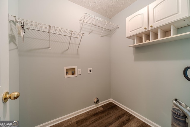 laundry room with cabinets, washer hookup, electric dryer hookup, dark wood-type flooring, and a textured ceiling