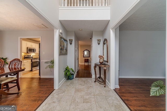 corridor with light hardwood / wood-style floors