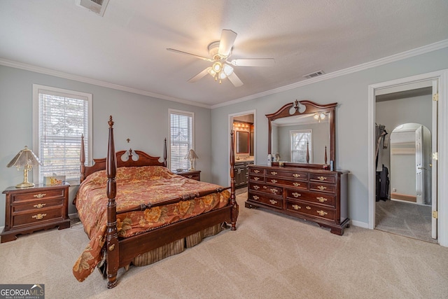 bedroom featuring a spacious closet, light colored carpet, ceiling fan, crown molding, and ensuite bath