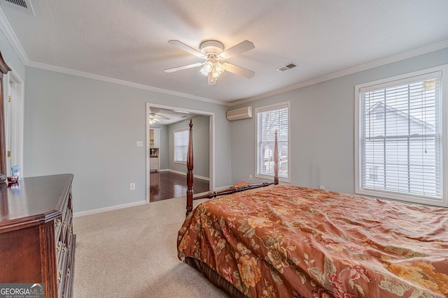 carpeted bedroom featuring ceiling fan, ornamental molding, an AC wall unit, and a textured ceiling