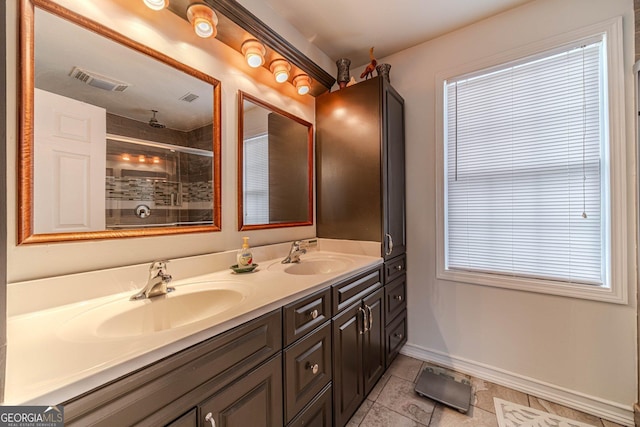 bathroom with vanity, tile patterned flooring, a wealth of natural light, and a shower with shower door