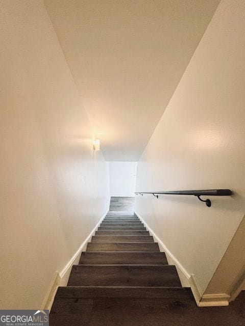 stairway with hardwood / wood-style flooring