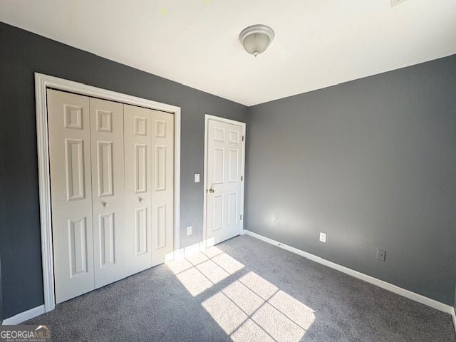 unfurnished bedroom with carpet floors and a closet