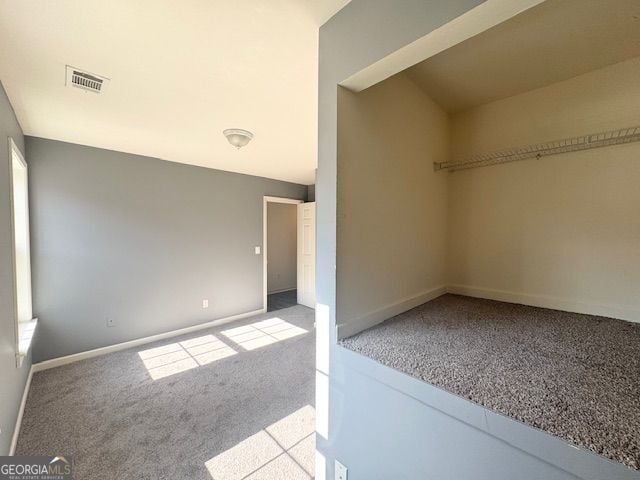 unfurnished room featuring light carpet