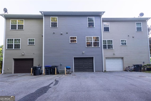 rear view of property featuring a garage