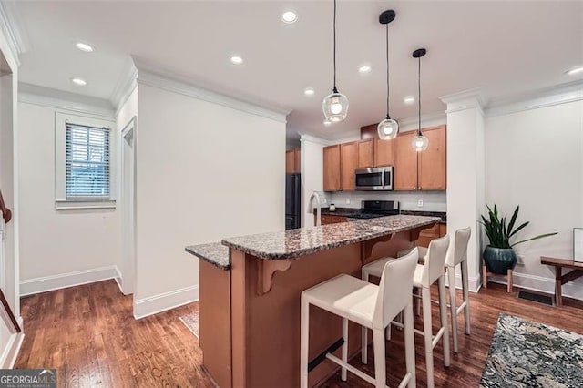 kitchen featuring black refrigerator, dark stone counters, hanging light fixtures, ornamental molding, and stove