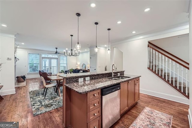 kitchen with sink, hanging light fixtures, ornamental molding, a center island with sink, and stainless steel dishwasher