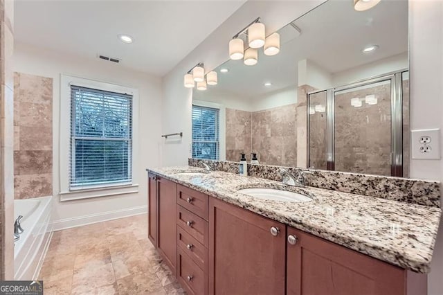 bathroom featuring independent shower and bath and vanity