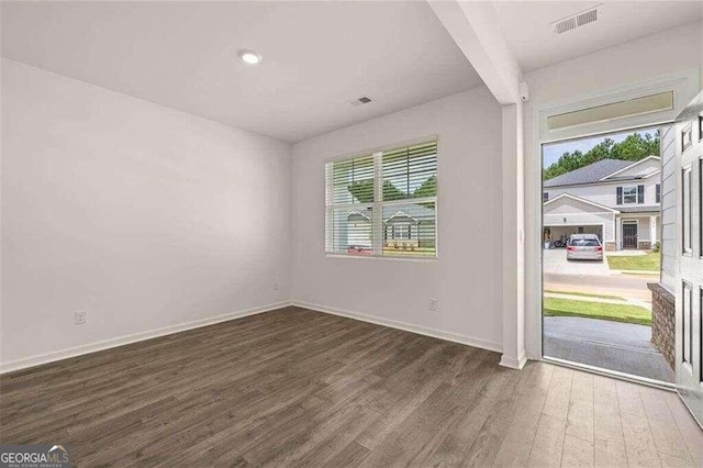 unfurnished room featuring dark hardwood / wood-style flooring