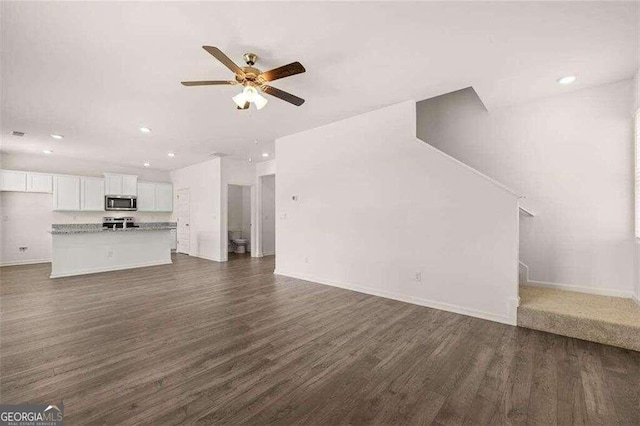 unfurnished living room with ceiling fan and dark hardwood / wood-style floors