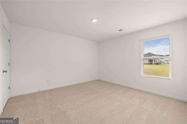 unfurnished room with light colored carpet