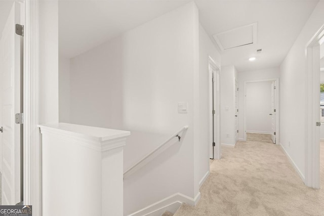 hallway with light colored carpet