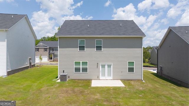 back of house featuring cooling unit, a yard, and a patio