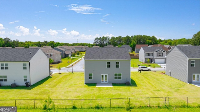 rear view of property featuring cooling unit, a yard, and a patio