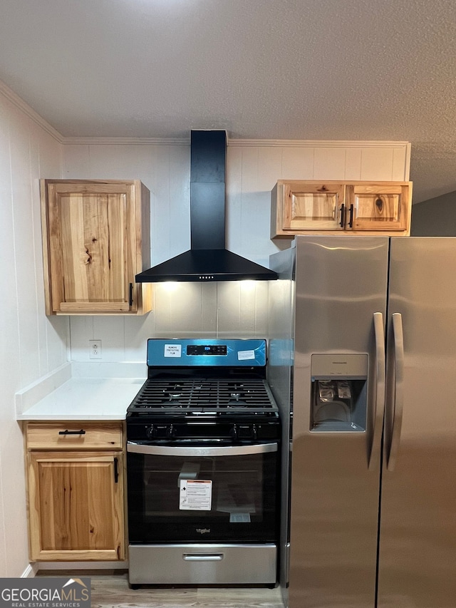 kitchen with stainless steel appliances and wall chimney range hood