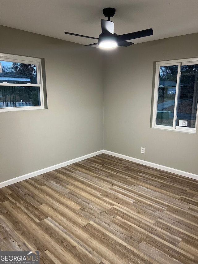 empty room featuring hardwood / wood-style floors and ceiling fan