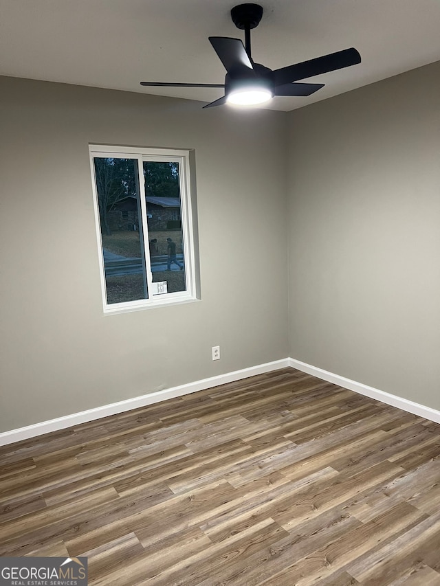 empty room with hardwood / wood-style floors and ceiling fan