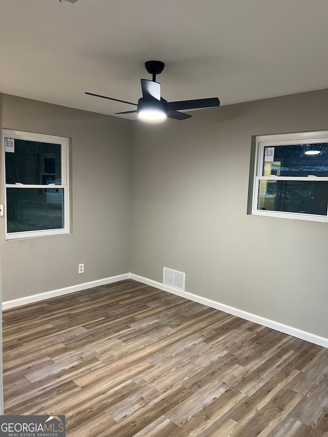 unfurnished room featuring hardwood / wood-style flooring and ceiling fan