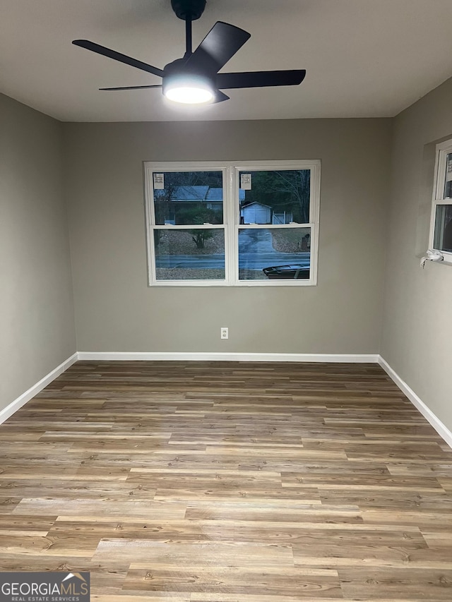 spare room with light hardwood / wood-style floors and ceiling fan