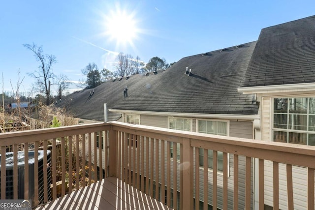 wooden deck featuring central AC unit