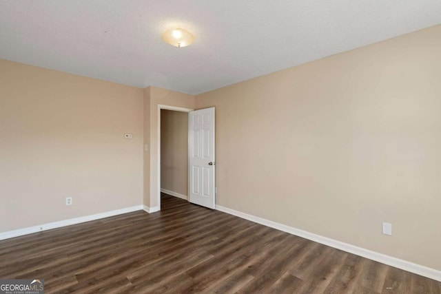 spare room featuring dark hardwood / wood-style flooring